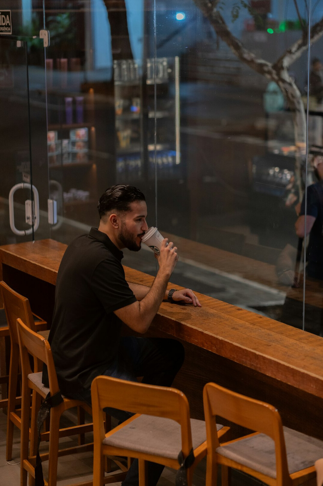 Duas pessoas conversando atentamente em uma mesa de madeira com anotações