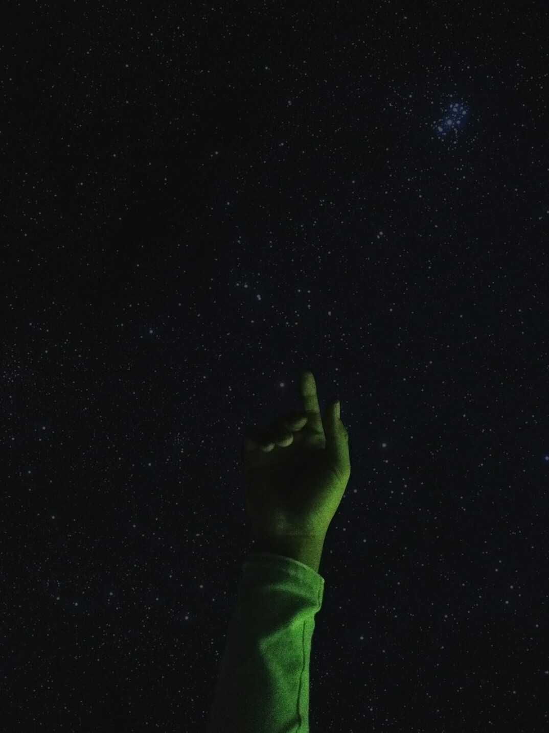 person reaching for stars