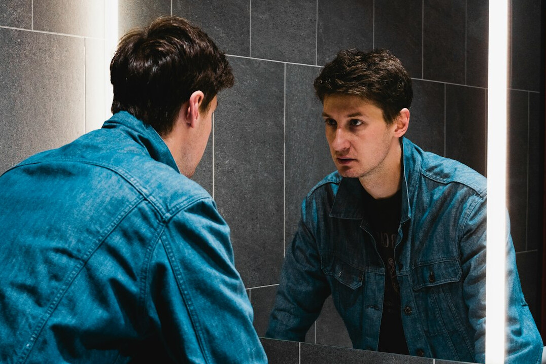 person reflecting in mirror