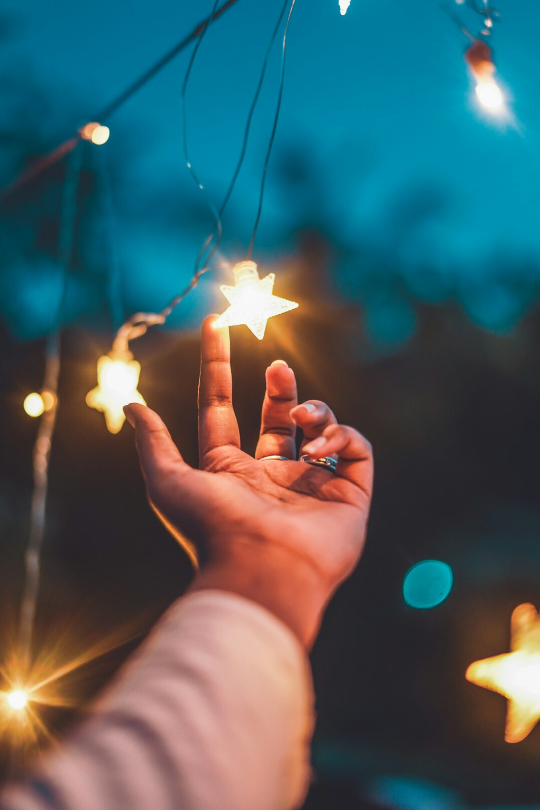 person reaching for stars